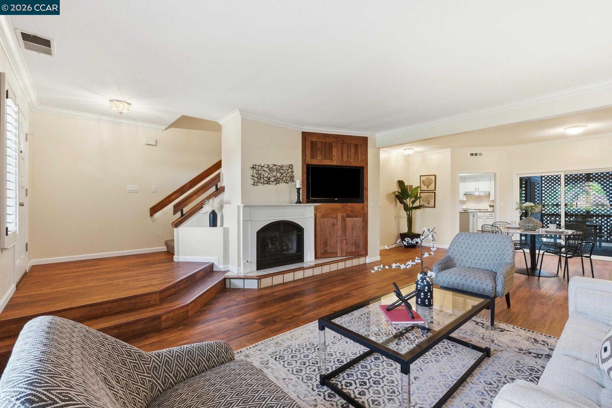 1707 Geary Road Walnut Creek, CA 94597 - Photo 7 of 43 a living room with furniture a fireplace and a flat screen tv