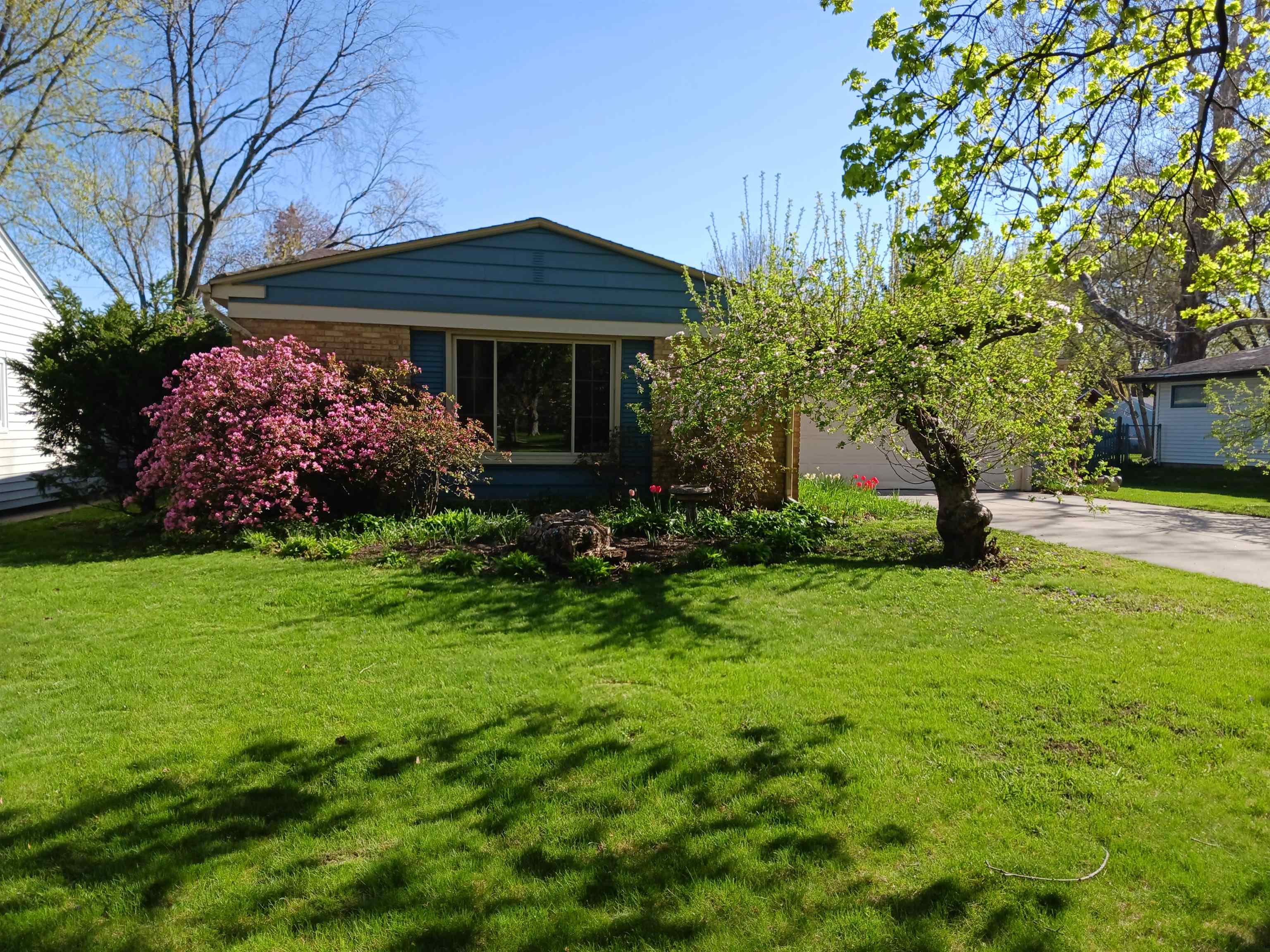 4819 Highcrest Road Rockford, IL 61107 - Photo 1 of 31 a front view of a house with garden