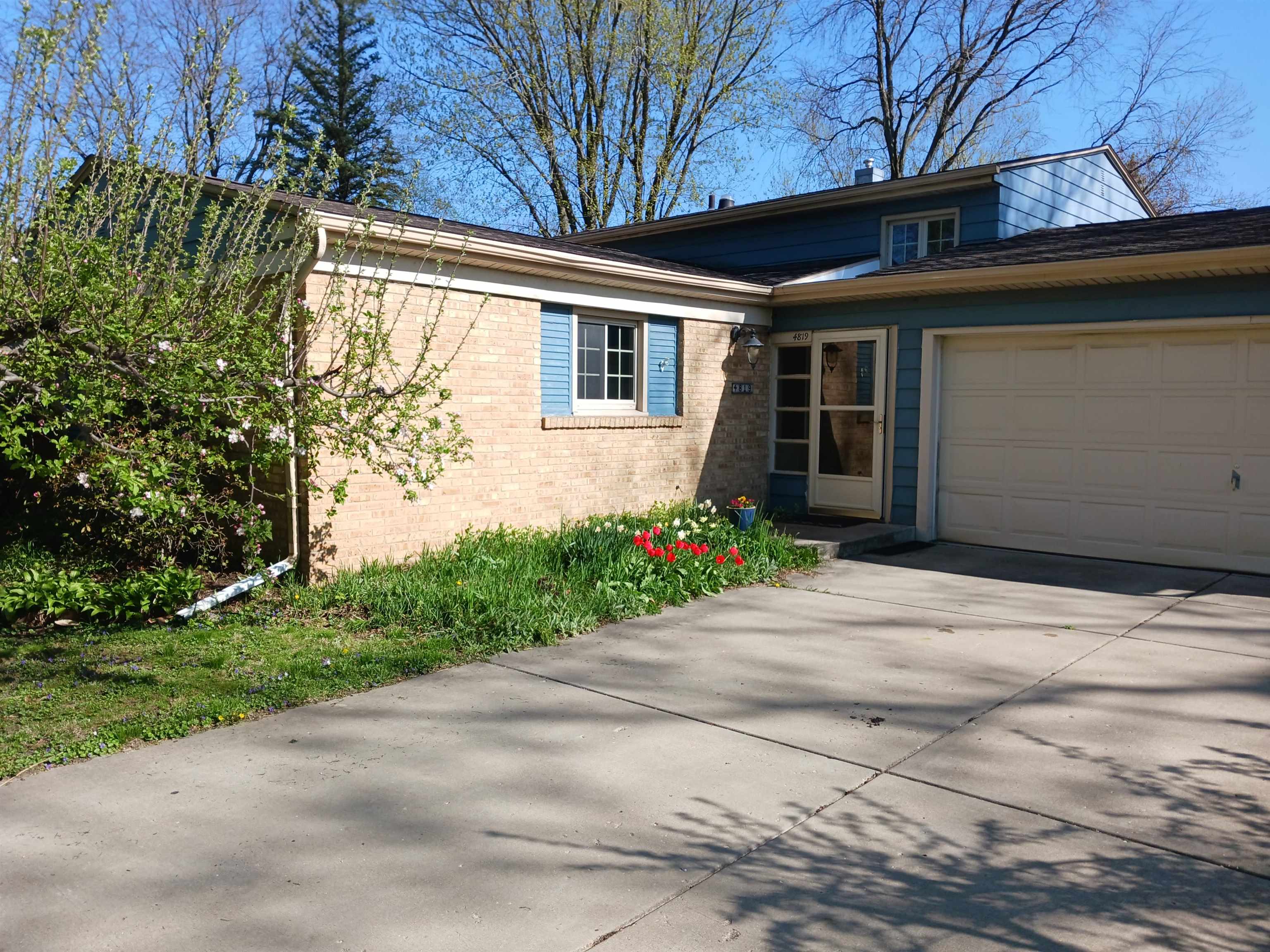 4819 Highcrest Road Rockford, IL 61107 - Photo 2 of 31 a front view of a house with a yard and garage