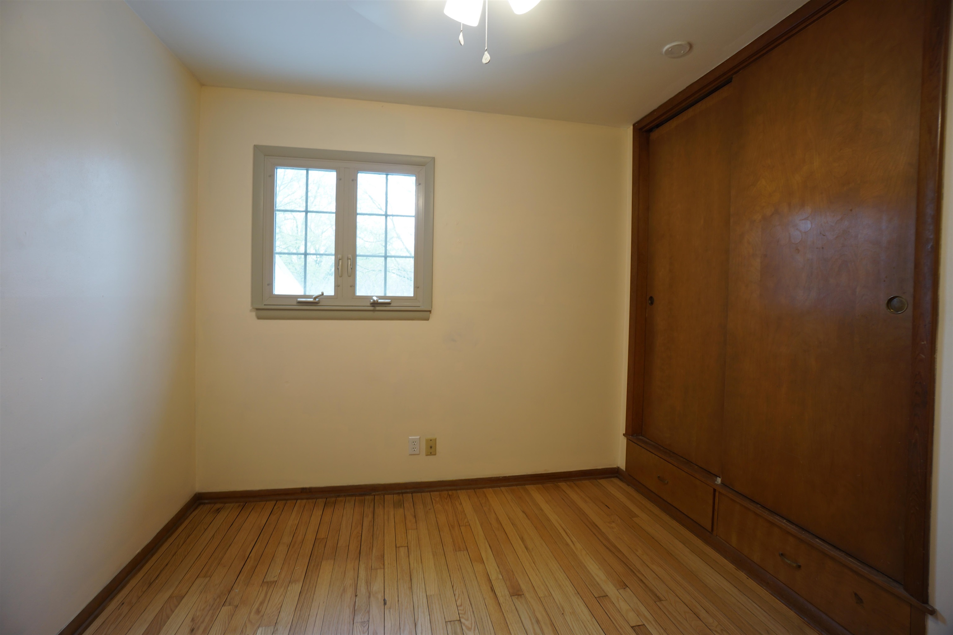 4819 Highcrest Road Rockford, IL 61107 - Photo 23 of 31 an empty room with wooden floor and windows