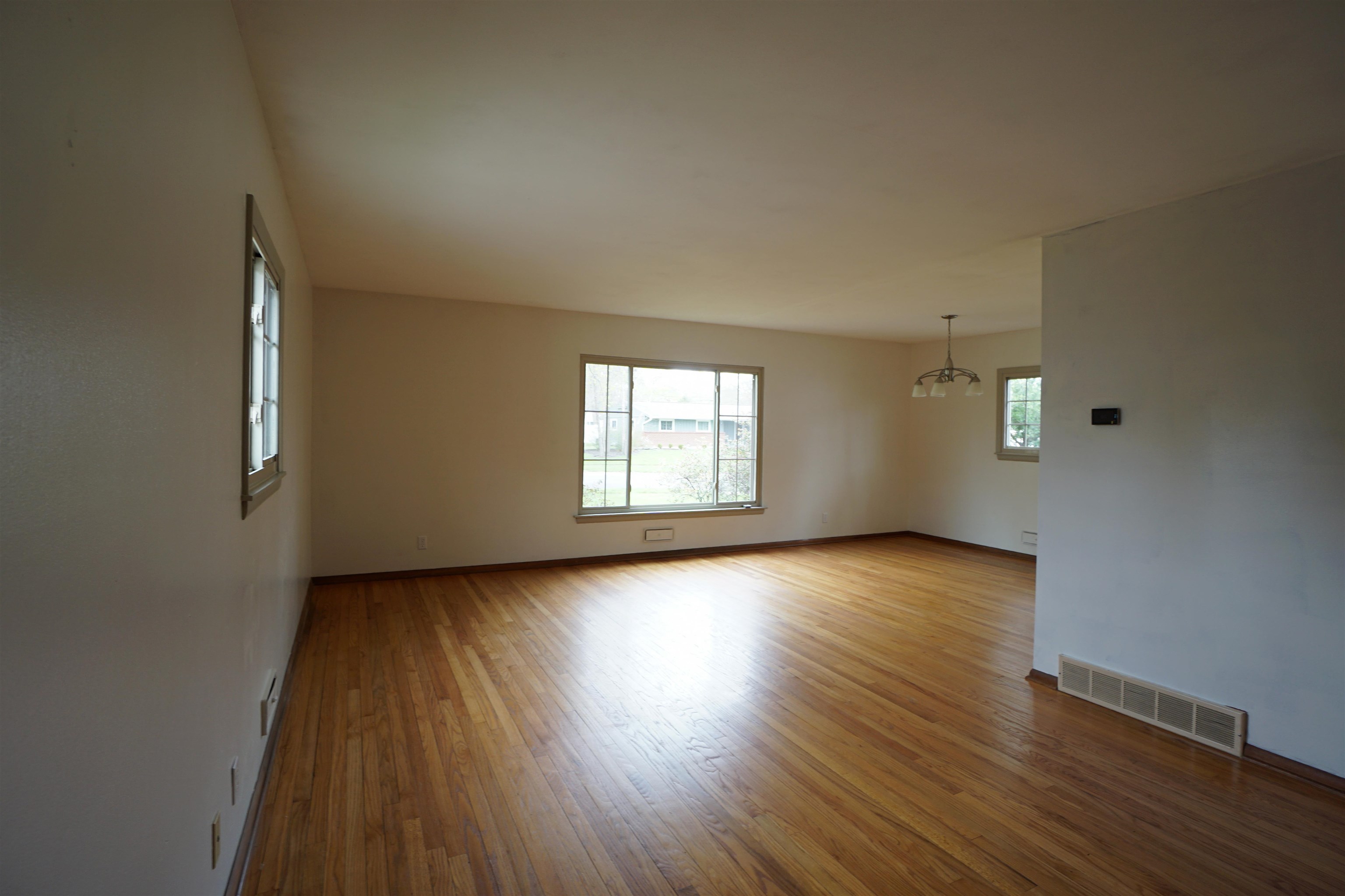 4819 Highcrest Road Rockford, IL 61107 - Photo 5 of 31 an empty room with wooden floor and windows