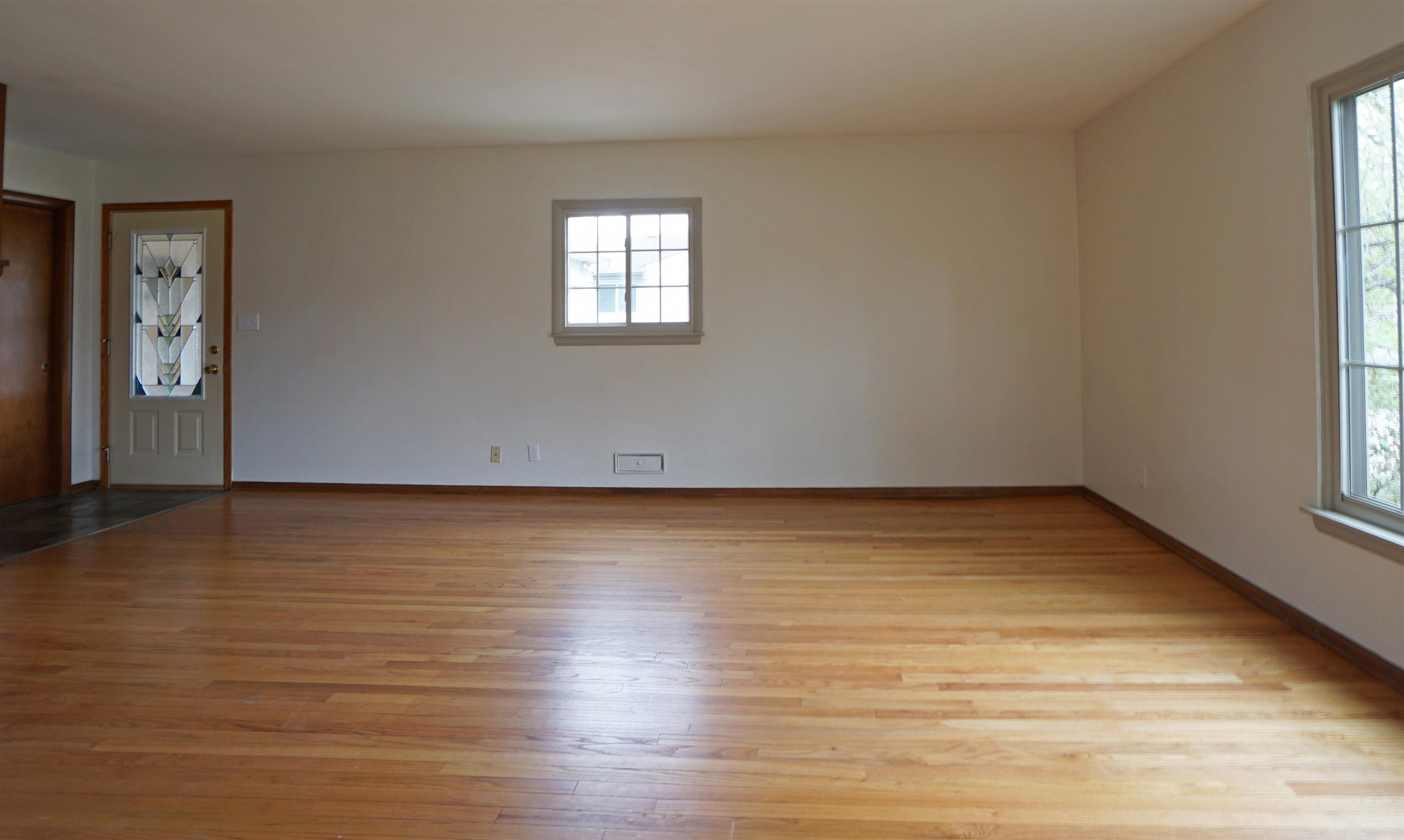 4819 Highcrest Road Rockford, IL 61107 - Photo 6 of 31 a view of an empty room with wooden floor and a window