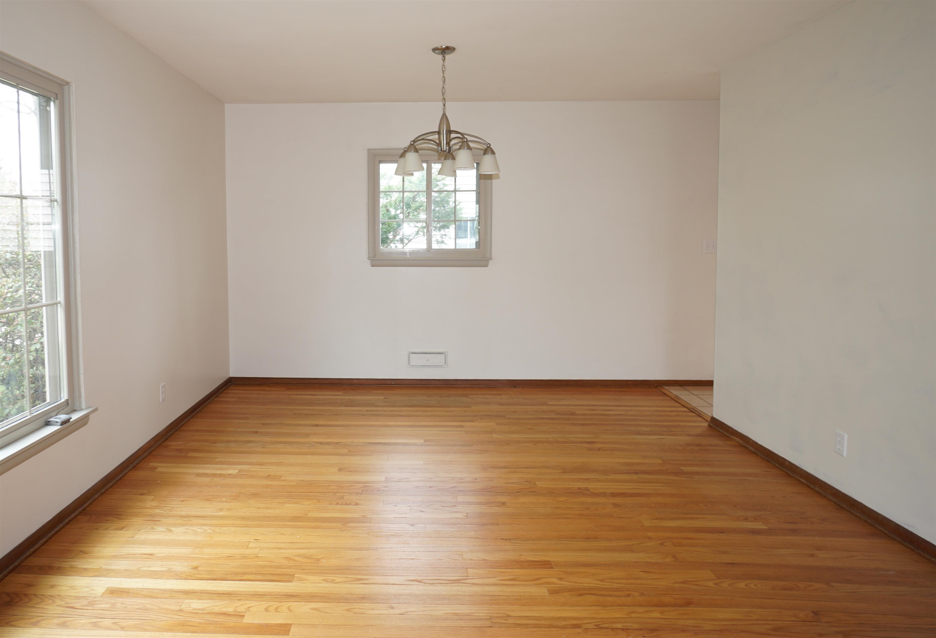 4819 Highcrest Road Rockford, IL 61107 - Photo 9 of 31 a view of an empty room with wooden floor and a window
