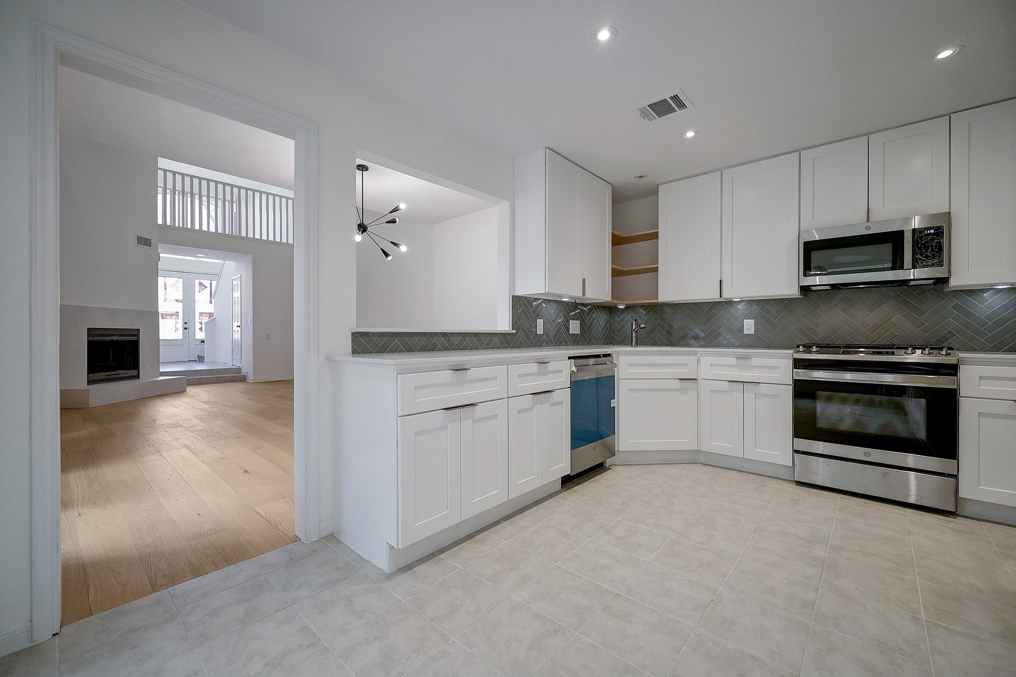 4311 Westheimer Road Houston, TX 77027 - Photo 7 of 23 a kitchen with stainless steel appliances granite countertop a stove top oven a sink and a refrigerator