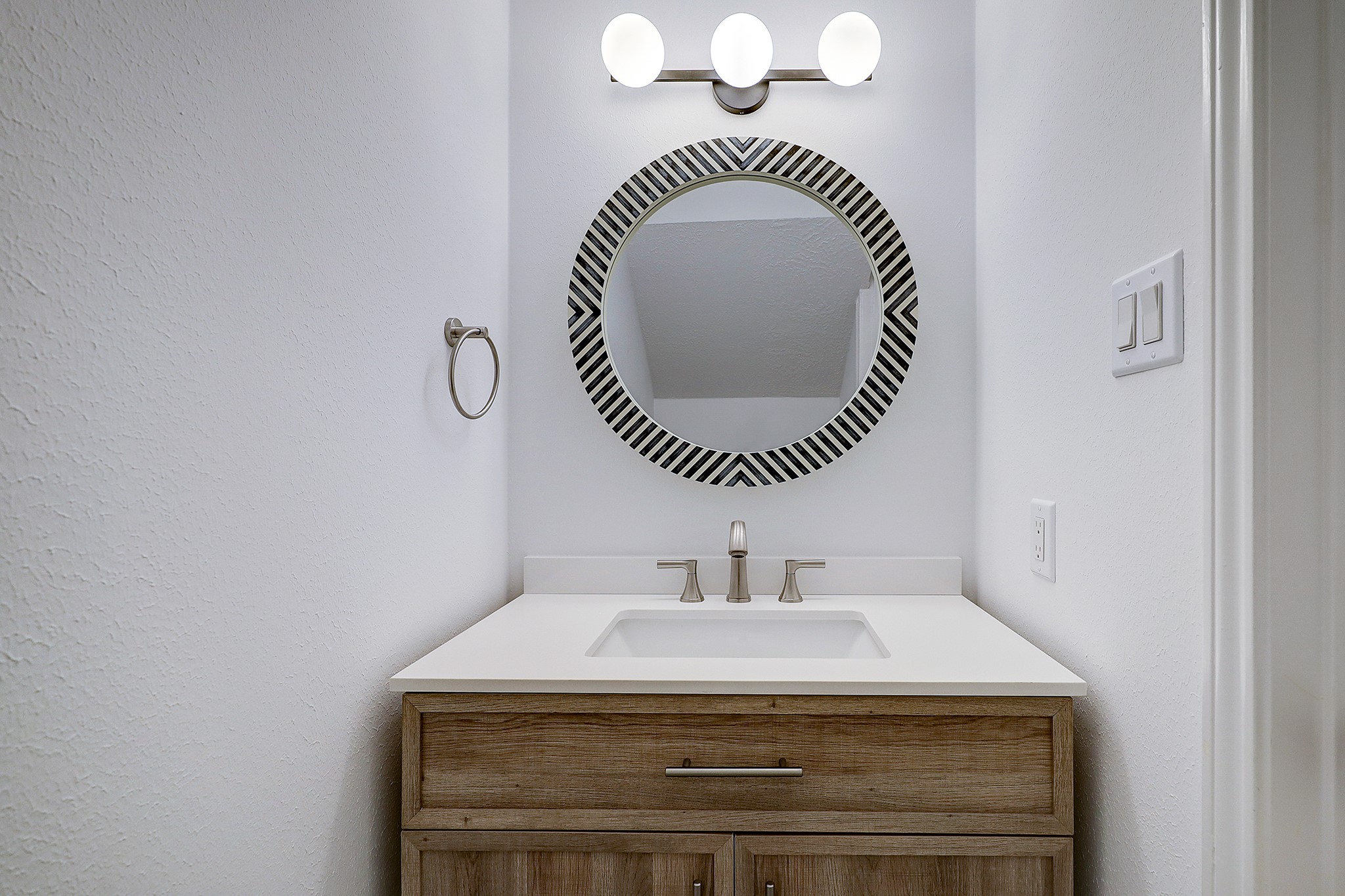 4311 Westheimer Road Houston, TX 77027 - Photo 10 of 23 a bathroom with a sink and a mirror