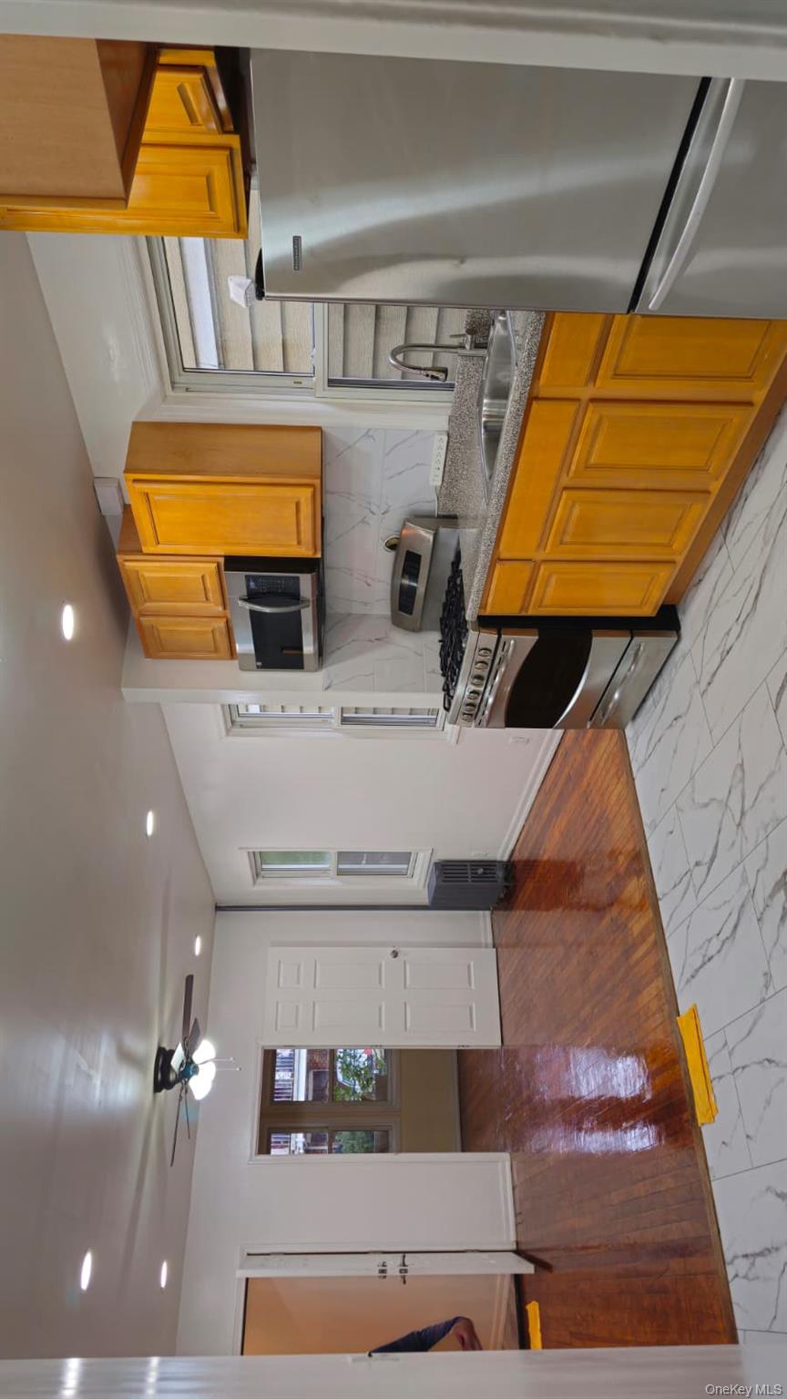 55-23 97th Place Queens, NY 11368 - Photo 1 of 7 a kitchen with stainless steel appliances granite countertop a refrigerator a stove top oven a sink and dishwasher