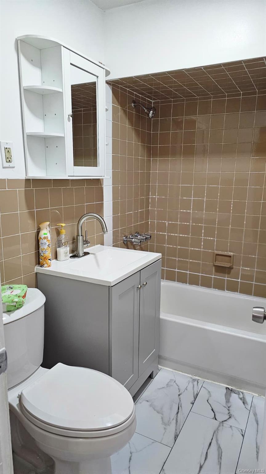 55-23 97th Place Queens, NY 11368 - Photo 3 of 7 a bathroom with a sink a toilet and shower
