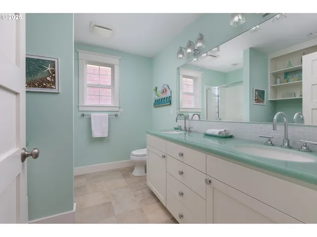 a bathroom with a granite countertop sink mirror and a toilet