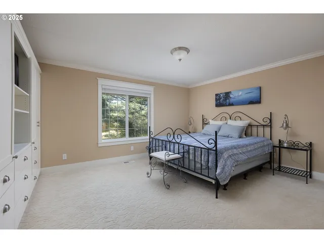 a bedroom with a bed window and a night stand in it