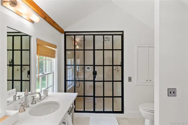 a bathroom with a bathtub a sink and a window