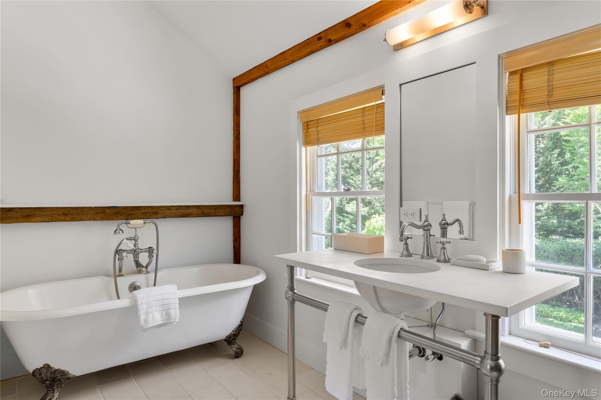 182 Church Lane Bridgehampton, NY 11932 - Photo 27 of 37 a bathroom with a bathtub a sink and a window