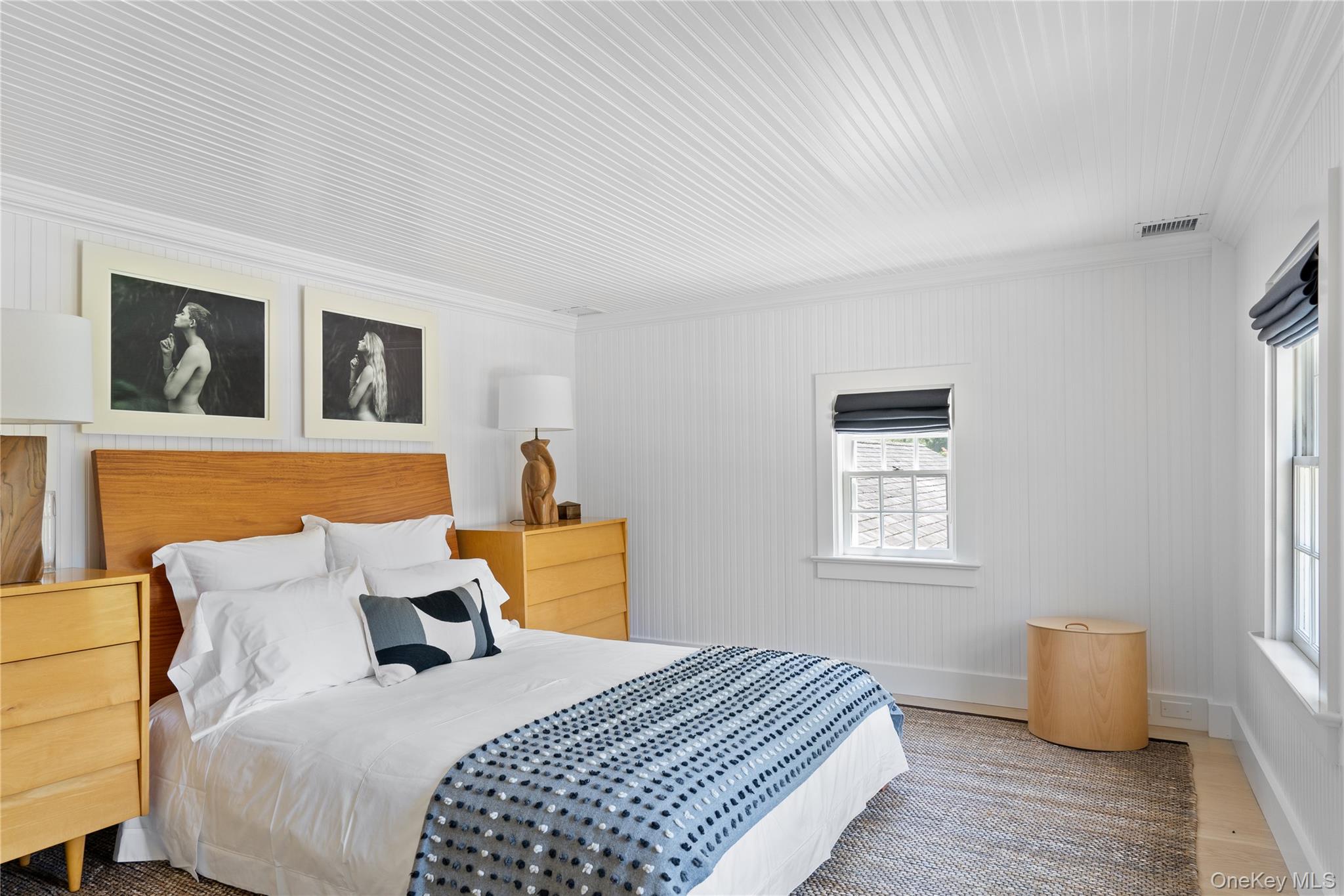 182 Church Lane Bridgehampton, NY 11932 - Photo 29 of 37 a bedroom with a bed and wooden floor