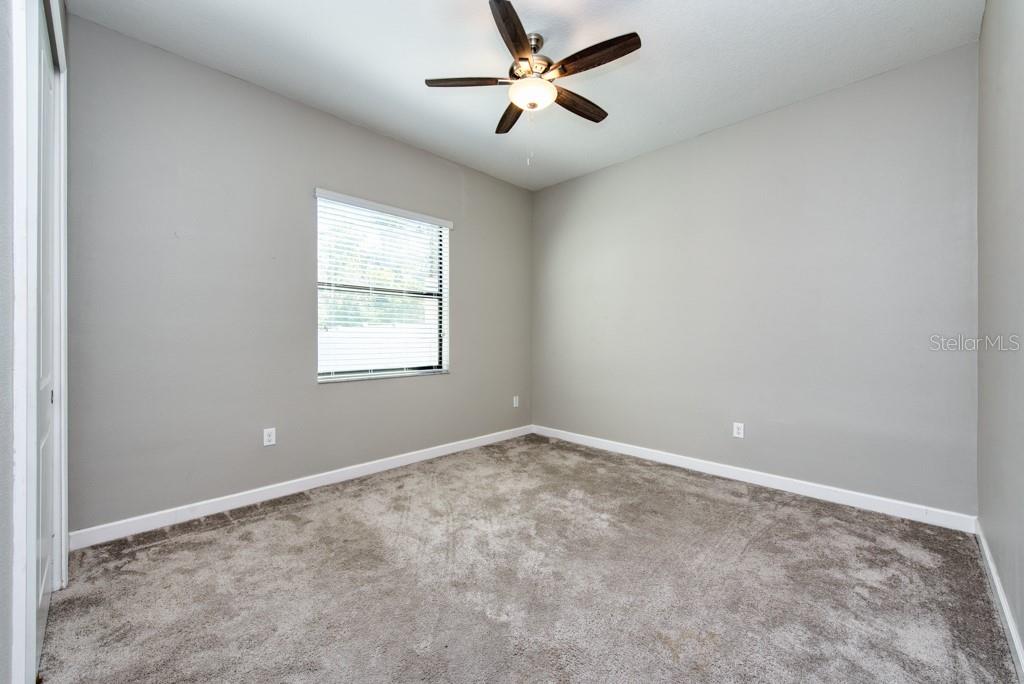 13315 Orca Sound Drive Riverview, FL 33579 - Photo 15 of 52 an empty room with windows and fan