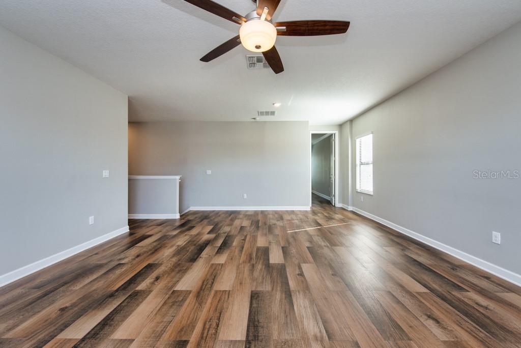 13315 Orca Sound Drive Riverview, FL 33579 - Photo 19 of 52 a view of empty room with wooden floor and fan