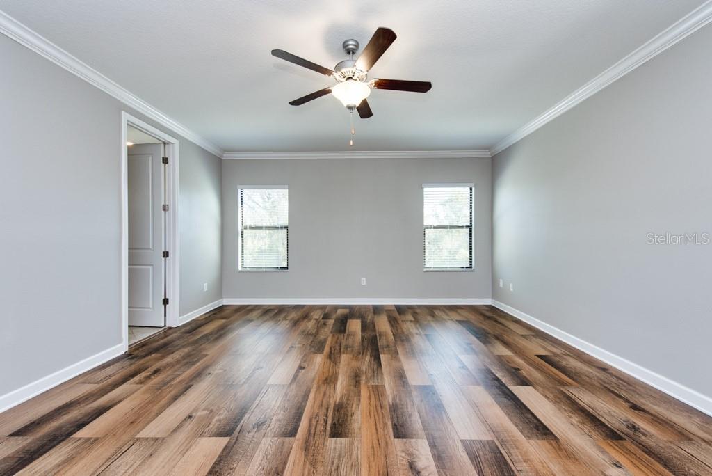 13315 Orca Sound Drive Riverview, FL 33579 - Photo 20 of 52 an empty room with wooden floor and windows