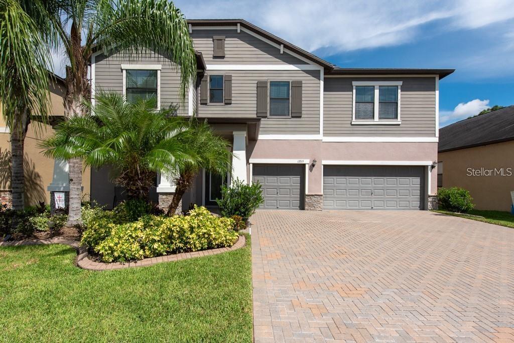 13315 Orca Sound Drive Riverview, FL 33579 - Photo 38 of 52 a front view of a house with a garden and plants