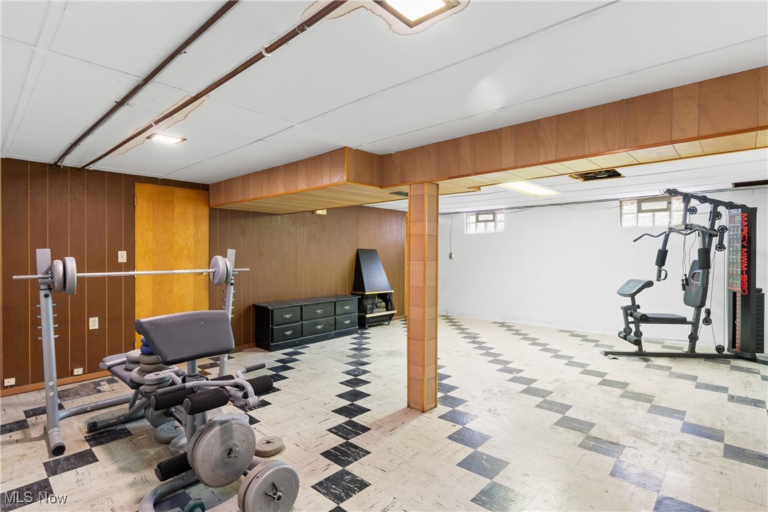 5415 12th Street Northwest Canton, OH 44708 - Photo 24 of 35 Workout room with tile patterned floors and wooden walls