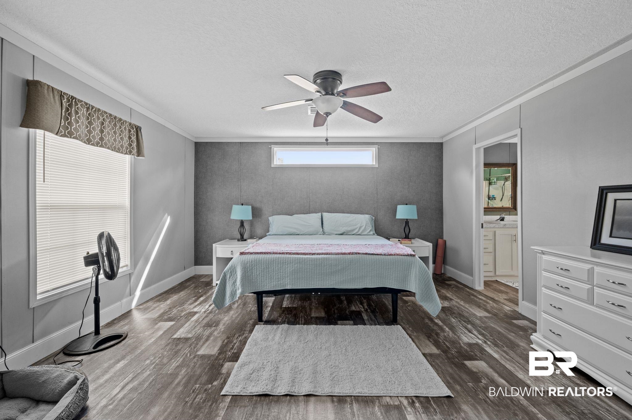 9382 D'Olive Street Bay Minette, AL 36507 - Photo 8 of 27 Bedroom featuring dark hardwood / wood-style floors, ensuite bath, ceiling fan, and crown molding