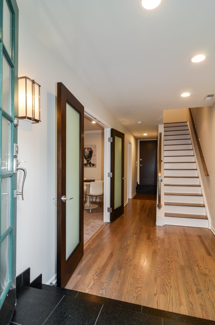 1014 West Grace Street Chicago, IL 60613 - Photo 3 of 24 a view of a hallway with wooden floor and cabinet