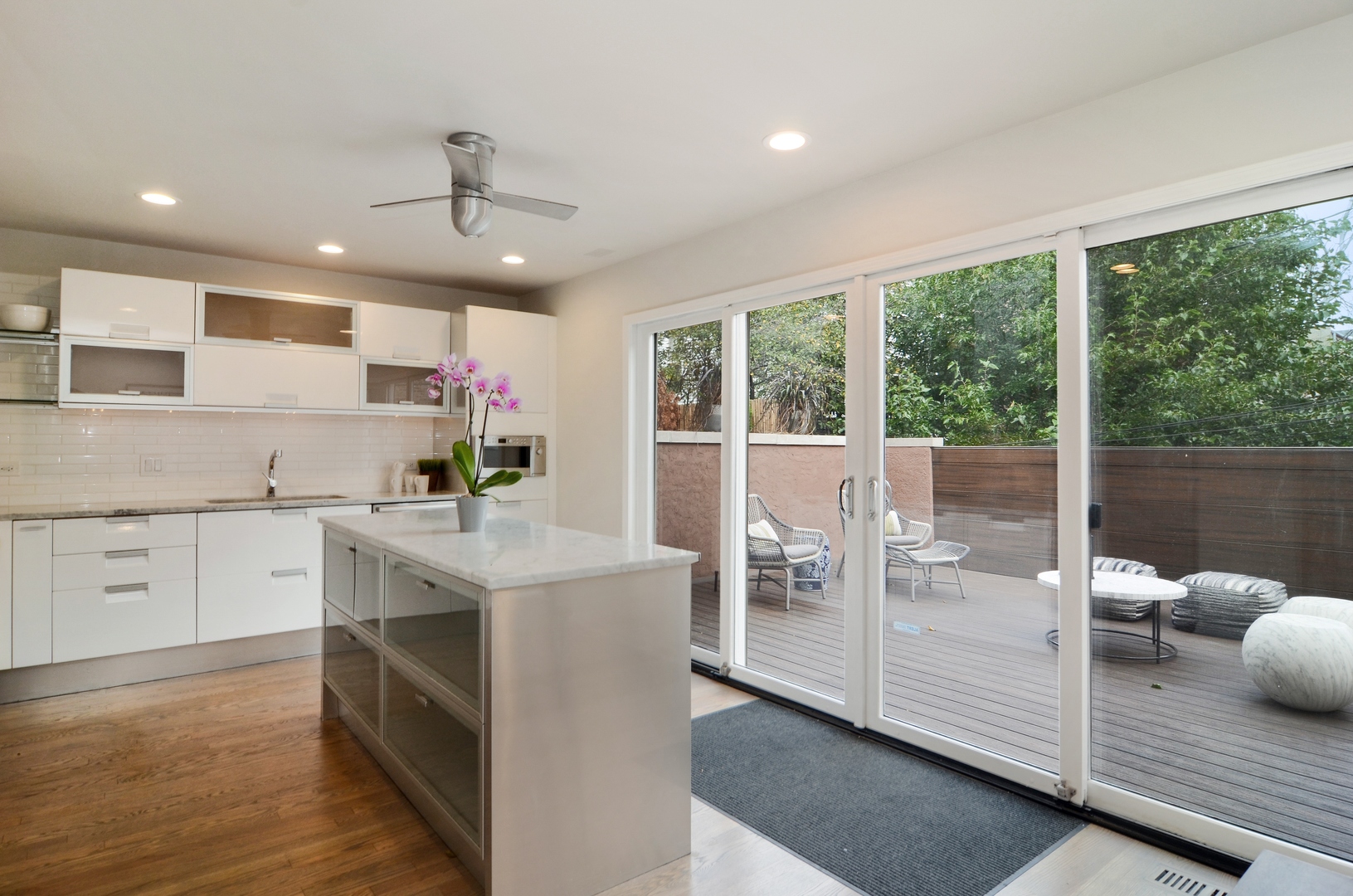 1014 West Grace Street Chicago, IL 60613 - Photo 7 of 24 a view of a kitchen with kitchen island granite countertop a large window cabinets and stainless steel appliances