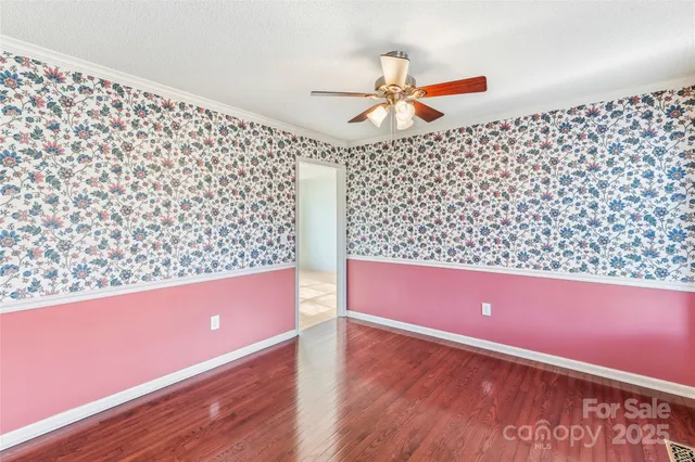 a view of room with window and wooden floor