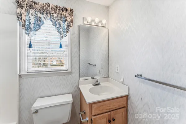 a bathroom with a sink toilet and a mirror