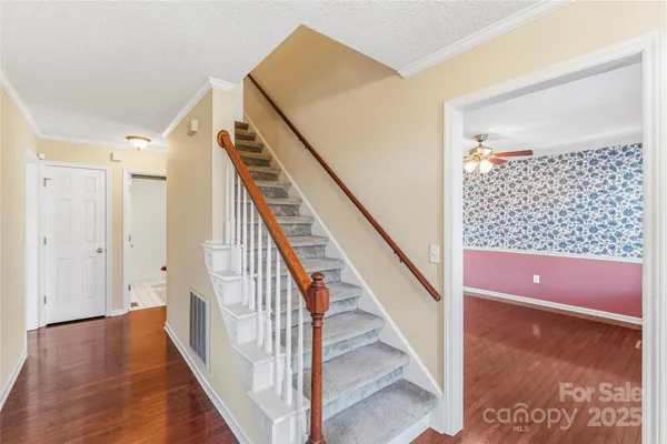 a view of entryway and hall with wooden floor