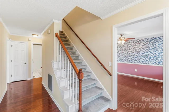 a view of entryway and hall with wooden floor