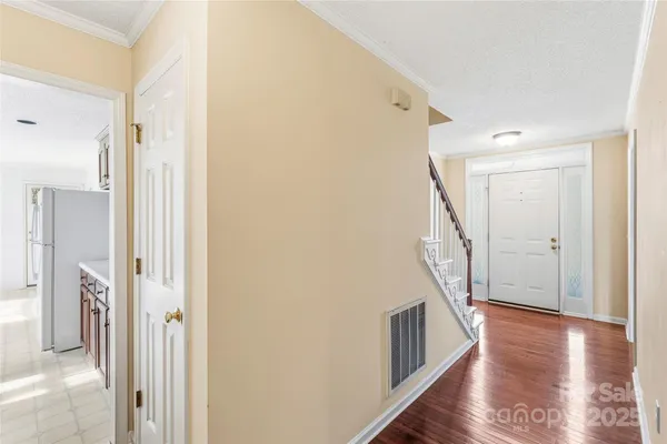 a view of a hallway view with wooden floor and staircase