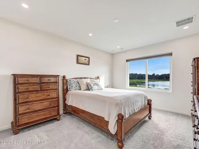 a bedroom with a bed and a night stand