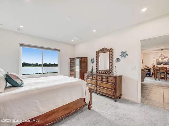 a spacious bedroom with a large bed and a large window