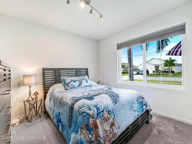 a bedroom with a bed and a night stand