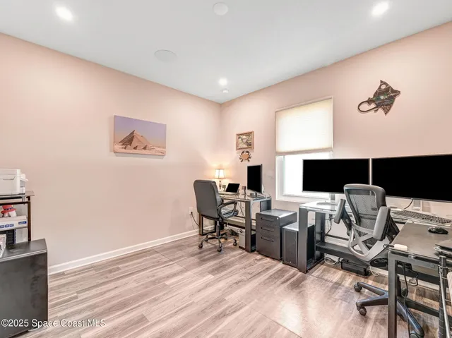 a dining room with furniture and a floor to ceiling window