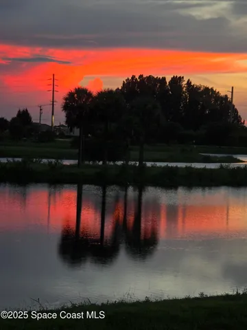 a view of a lake with houses in the back