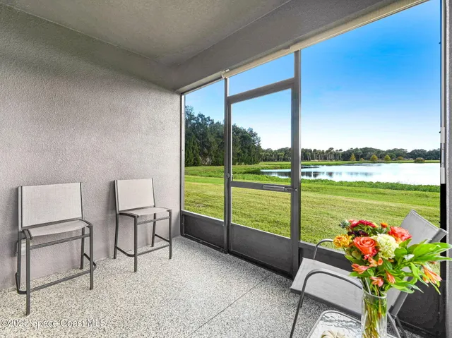 a living room with furniture and a floor to ceiling window