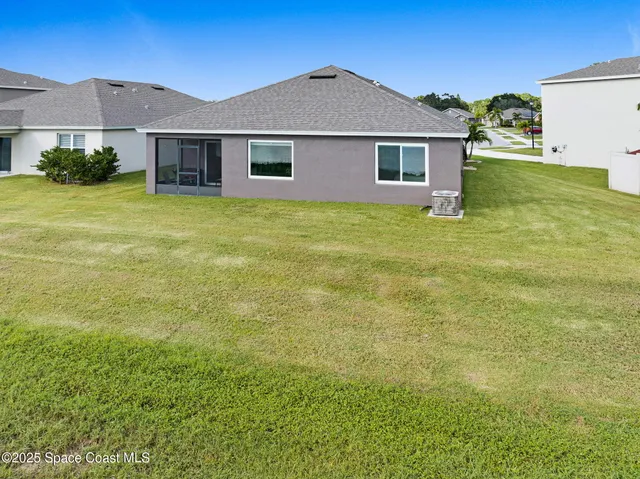 an aerial view of a house with a yard and garden
