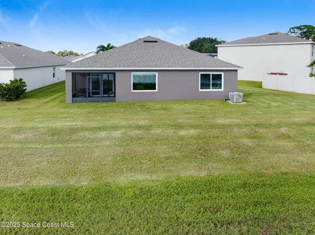 an aerial view of a house with a lake view