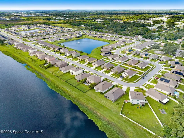 an aerial view of a house with garden space and outdoor seating