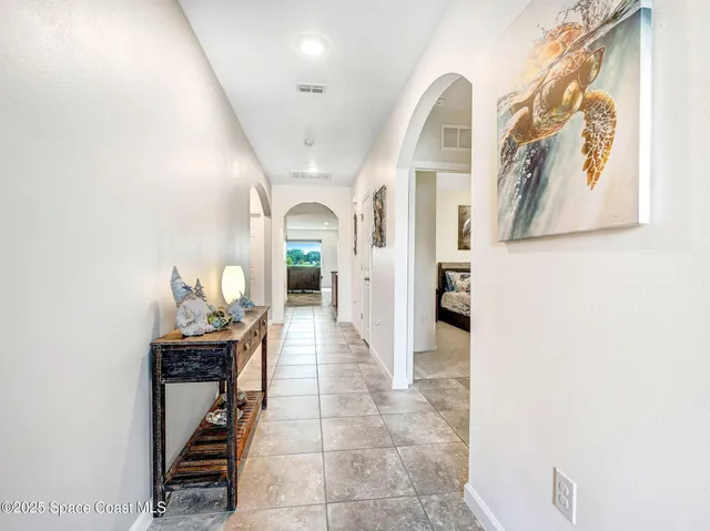 a view of a livingroom with wooden floor and a sink