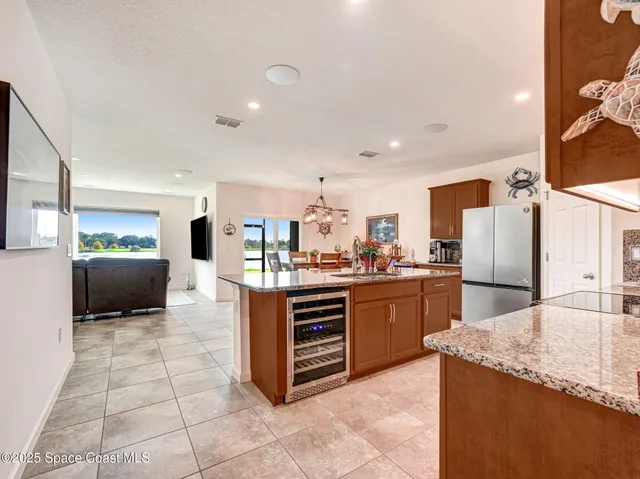 a kitchen with granite countertop a sink stove and cabinets