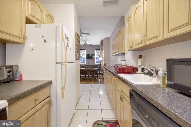 a kitchen with granite countertop a sink appliances and cabinets