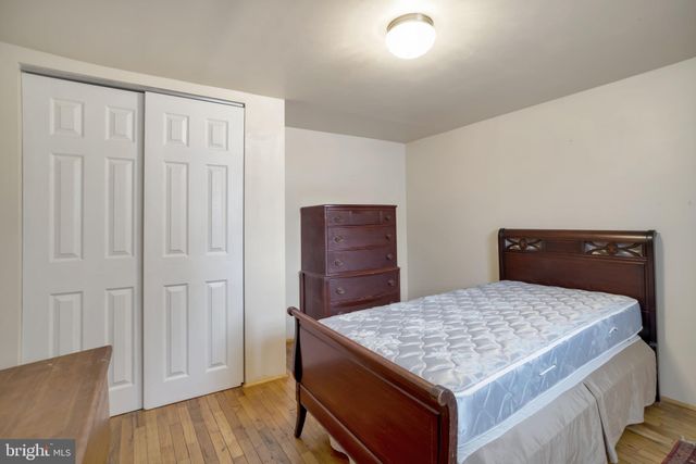 a bedroom with a table and dresser