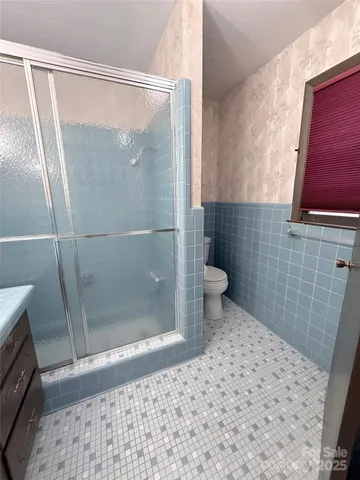 a living room with furniture gym equipment and a large window