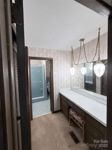 a bathroom with a tub sink and mirror