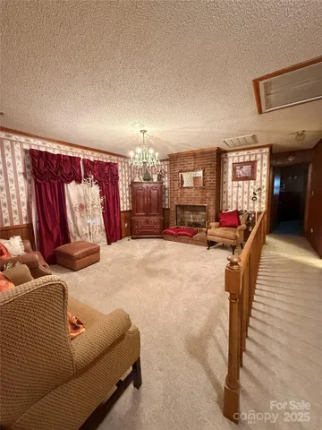 a view of a room with furniture ceiling fan and windows