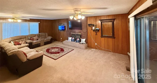 en empty room with windows and fan