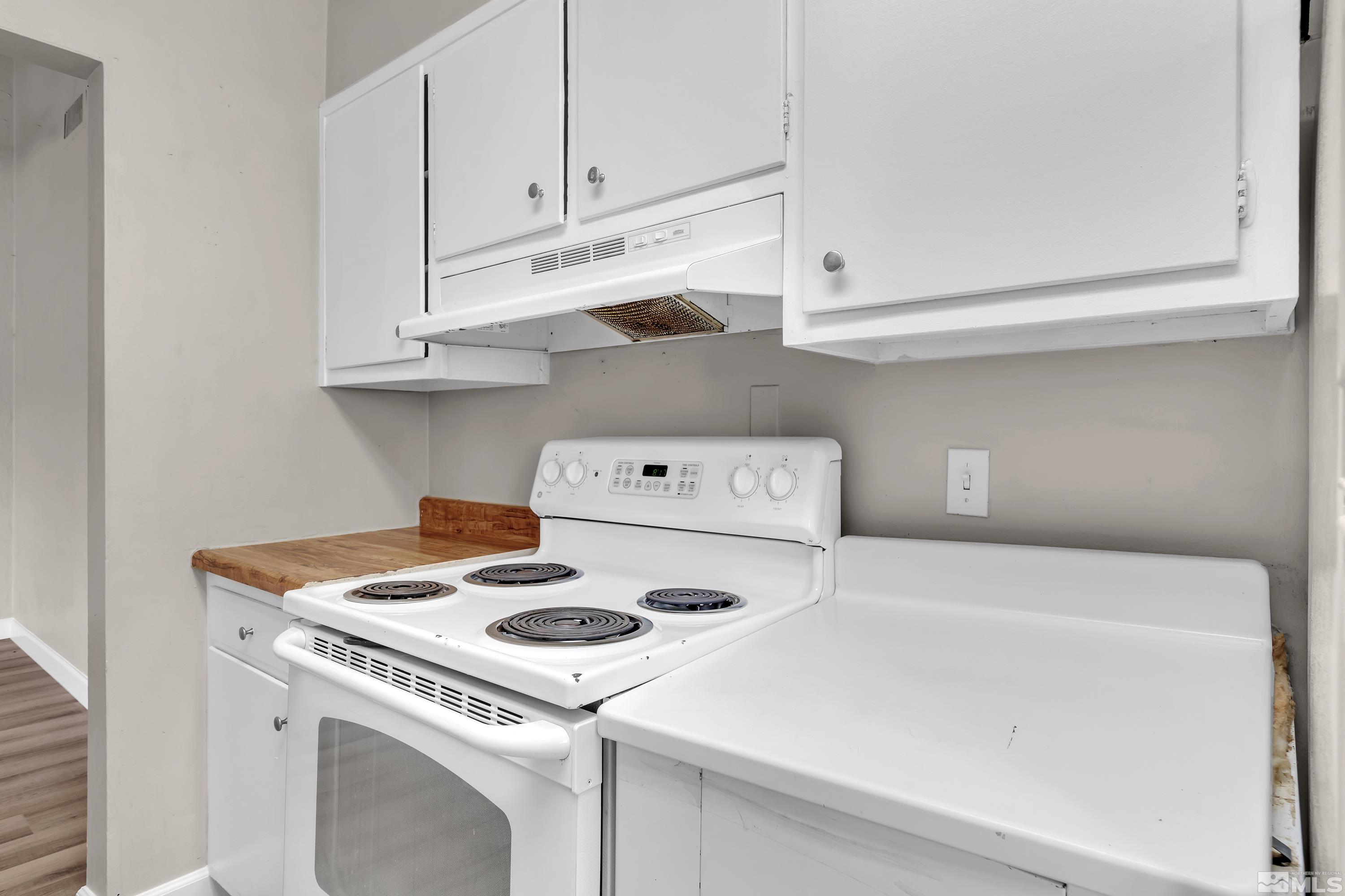 12190 Himalaya Street Reno, NV 89506 - Photo 13 of 34 a white stove top oven sitting inside of a kitchen