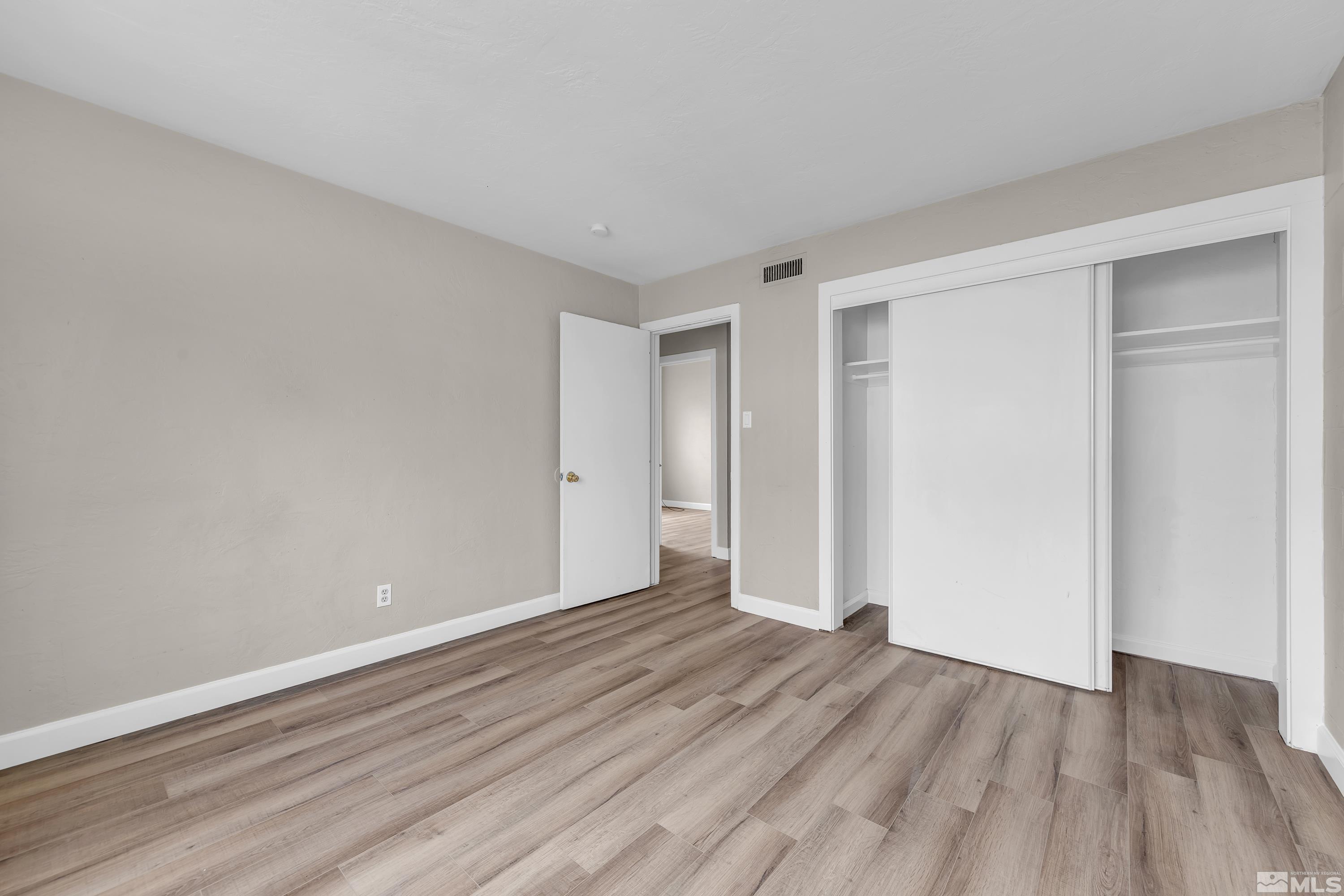 12190 Himalaya Street Reno, NV 89506 - Photo 15 of 34 a view of an empty room with wooden floor