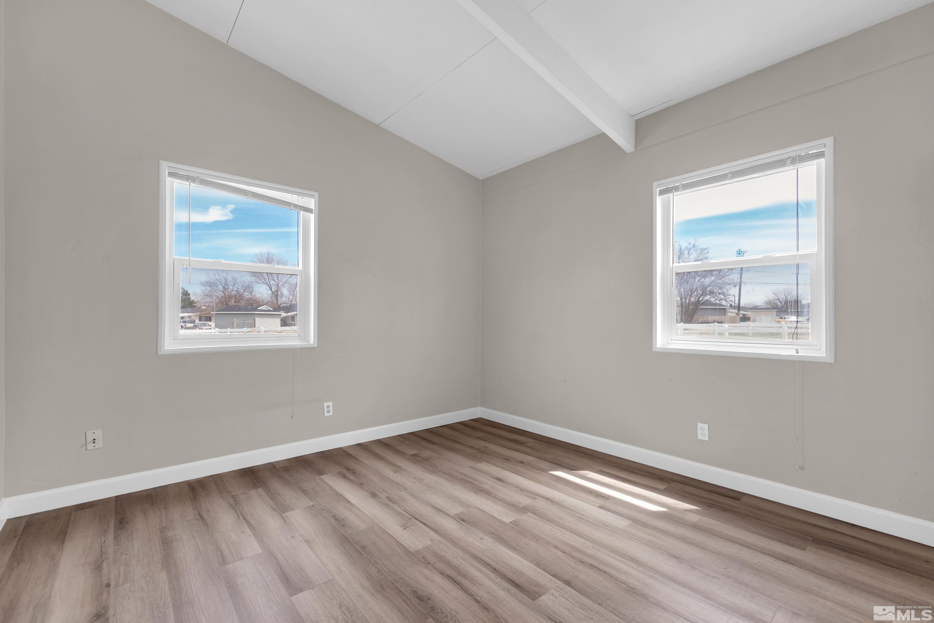 12190 Himalaya Street Reno, NV 89506 - Photo 16 of 34 a view of an empty room with wooden floor and a window