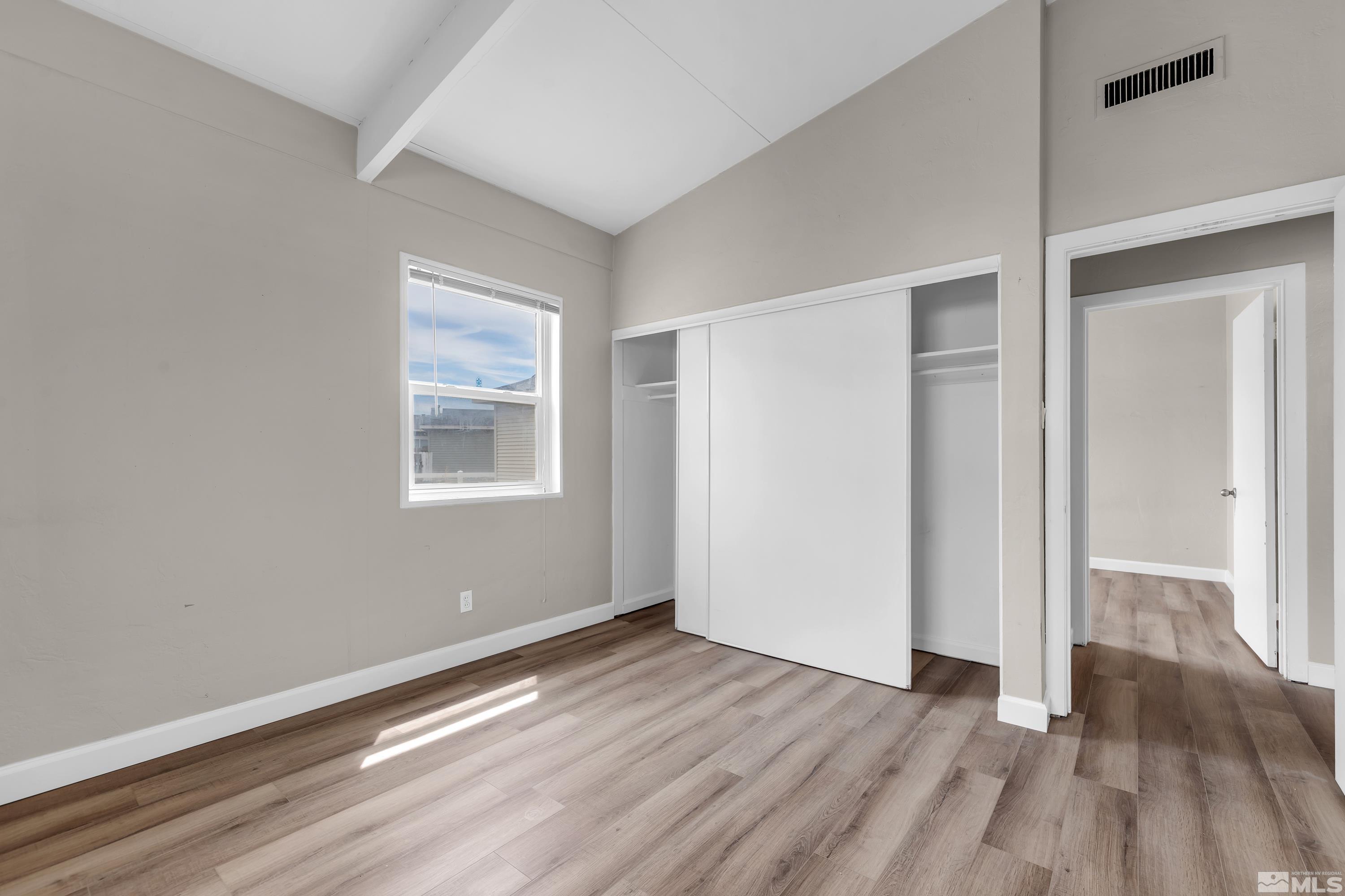 12190 Himalaya Street Reno, NV 89506 - Photo 17 of 34 a view of an empty room with wooden floor and a window